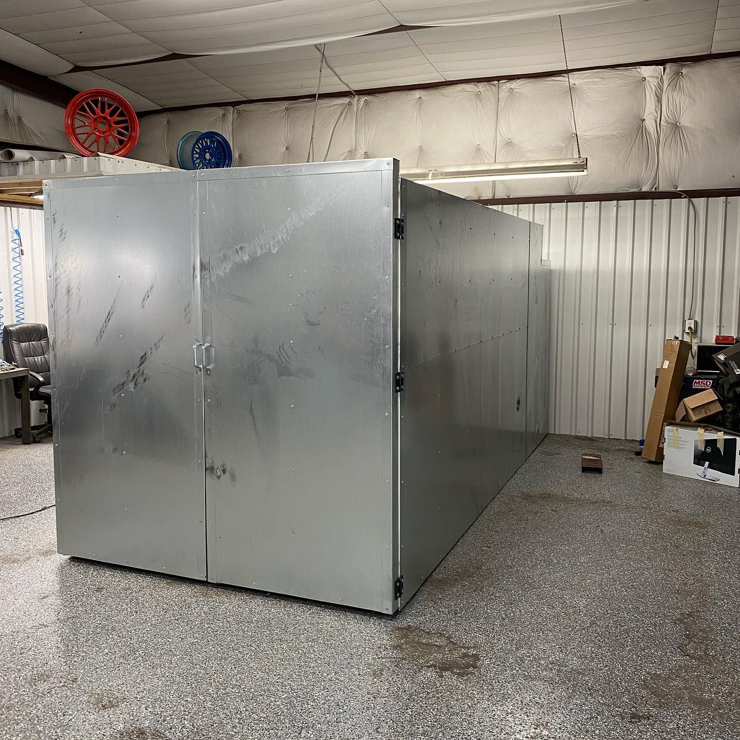 Large, rectangular, metal industrial oven in a workshop.