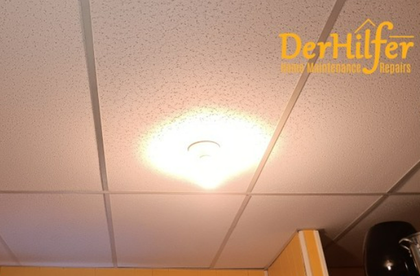 Bright overhead light in a white ceiling, illuminating the room.