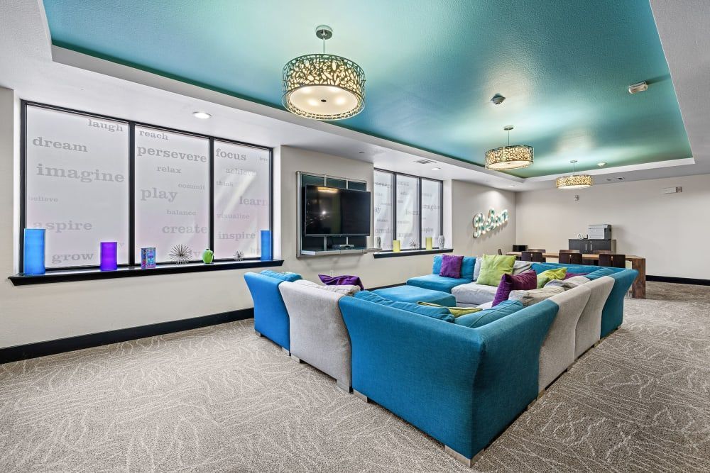 Apartment community clubhouse with blue and white couches and a blue ceiling at Regents West at 24th in Austin, TX, near West Campus.
