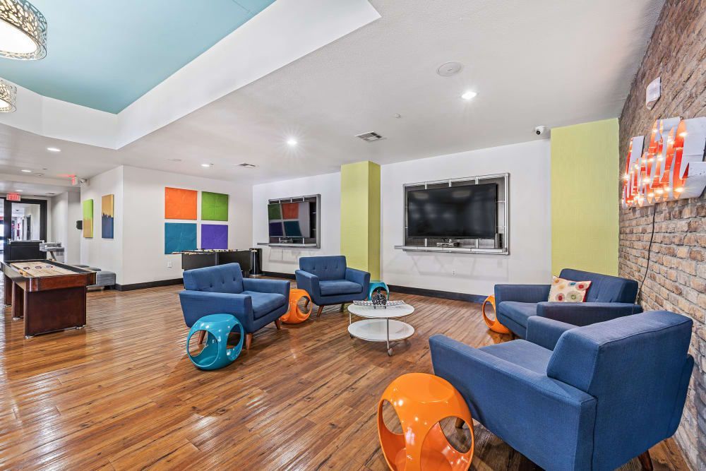Resident lounge filled with furniture and a pool table at Regents West at 24th in Austin, TX, near West Campus.