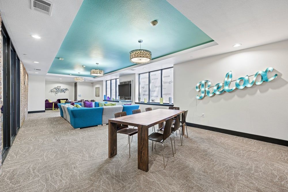 Clubhouse with a table and chairs at Regents West at 24th in Austin, TX, near West Campus.