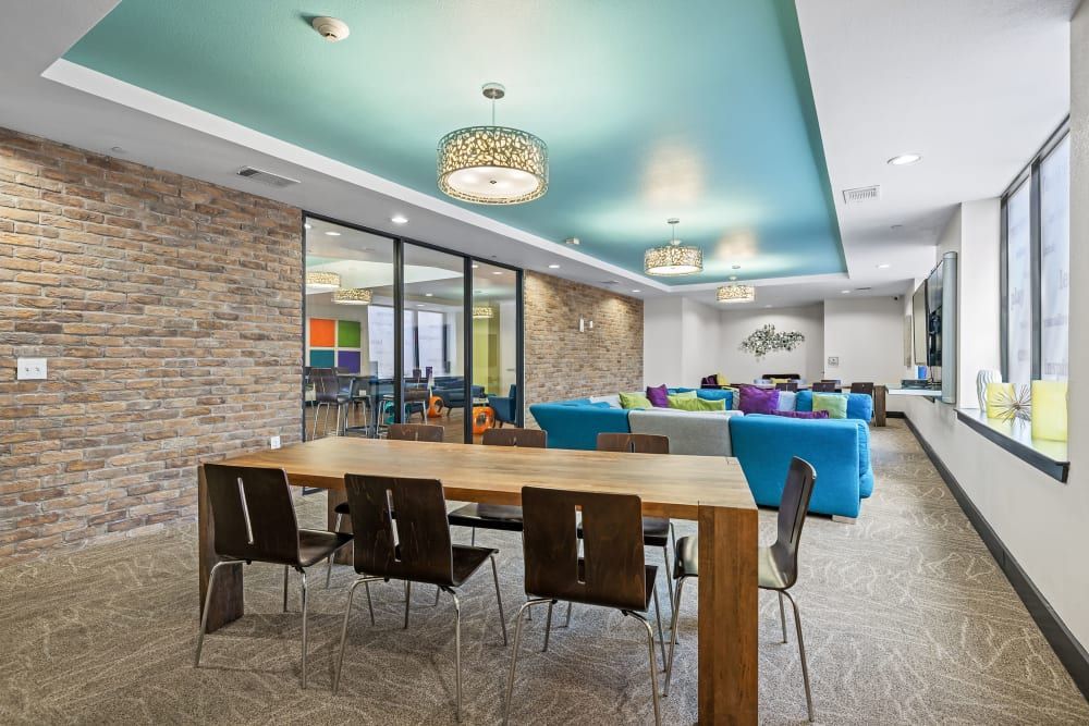 Student apartment community clubhouse with a table and chairs at Regents West at 24th in Austin, TX, near West Campus.