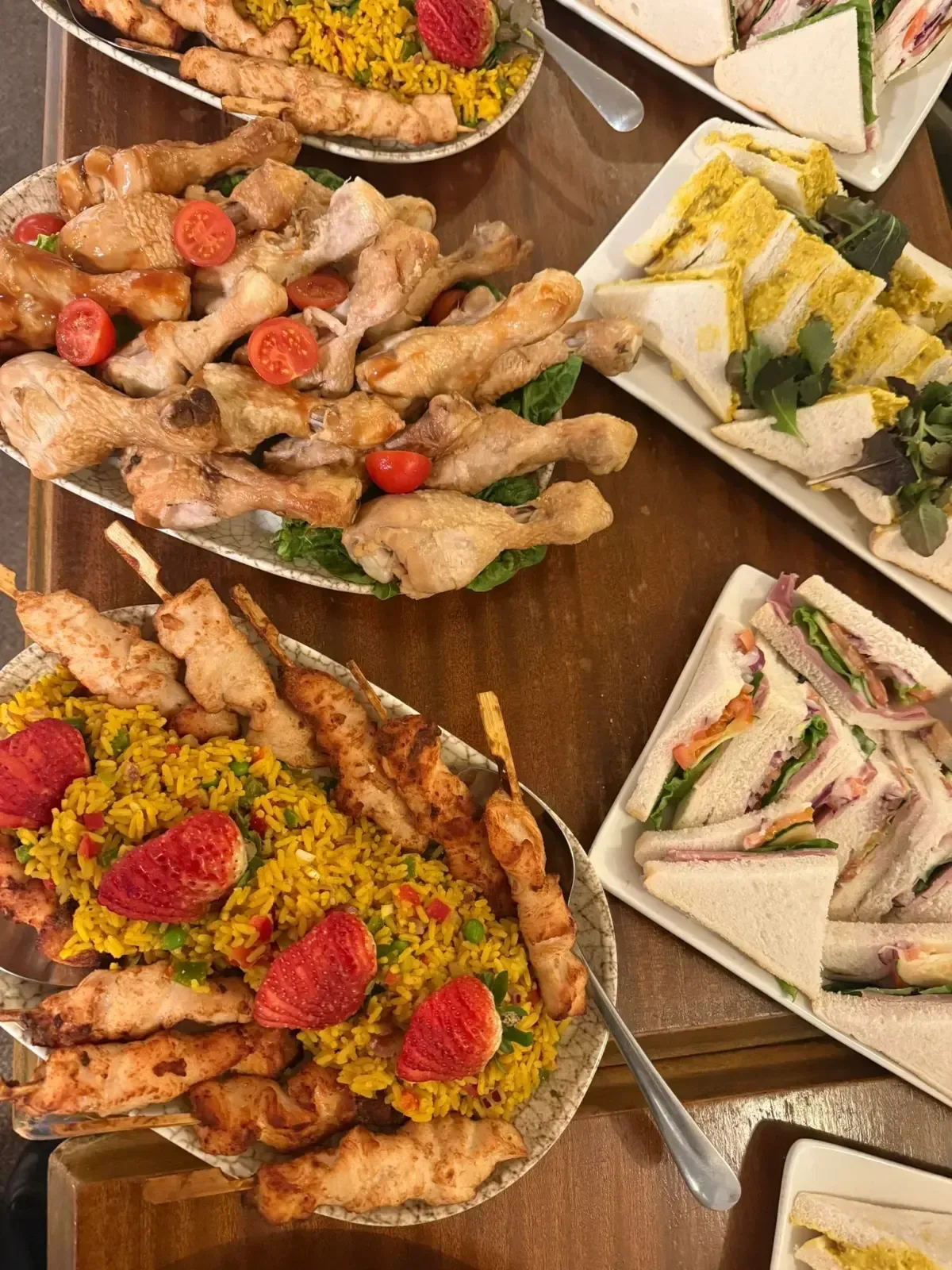 The Mackworth Arms, Laleston, Bridgend | Platters of food: fried chicken, skewers, sandwiches, and couscous on a wooden table