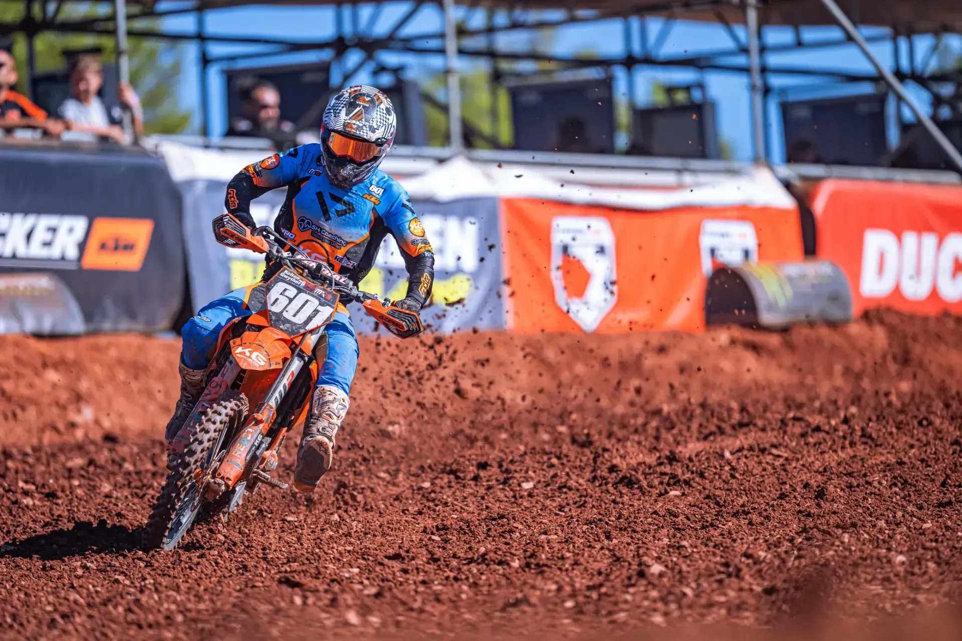A person is riding a dirt bike on a dirt track.