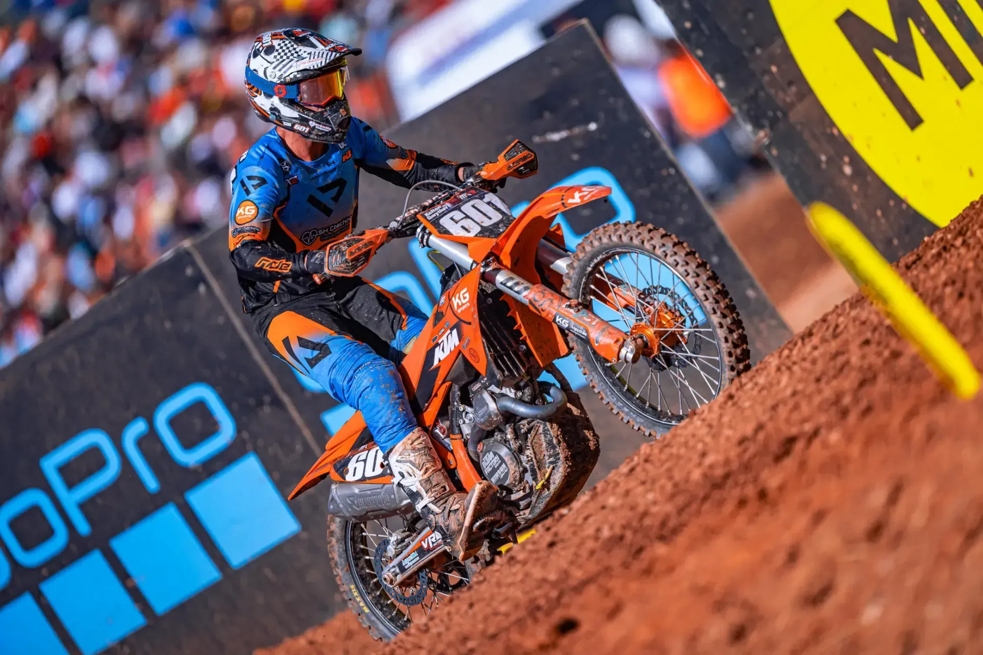 A man is riding a dirt bike on a dirt track.