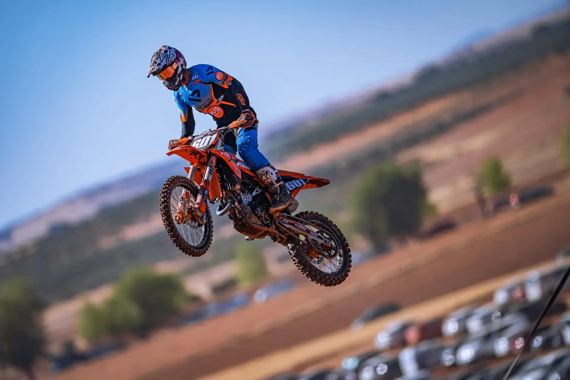 A man is riding a dirt bike on a dirt track.