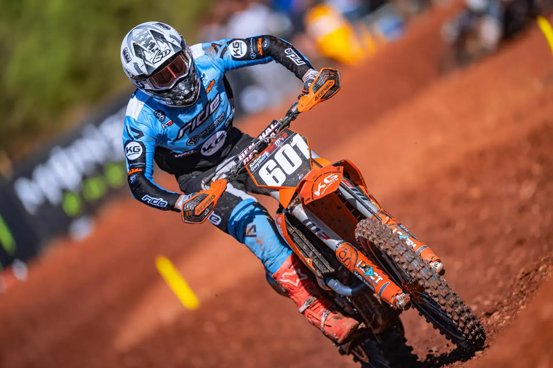 A man is riding a dirt bike on a dirt track.