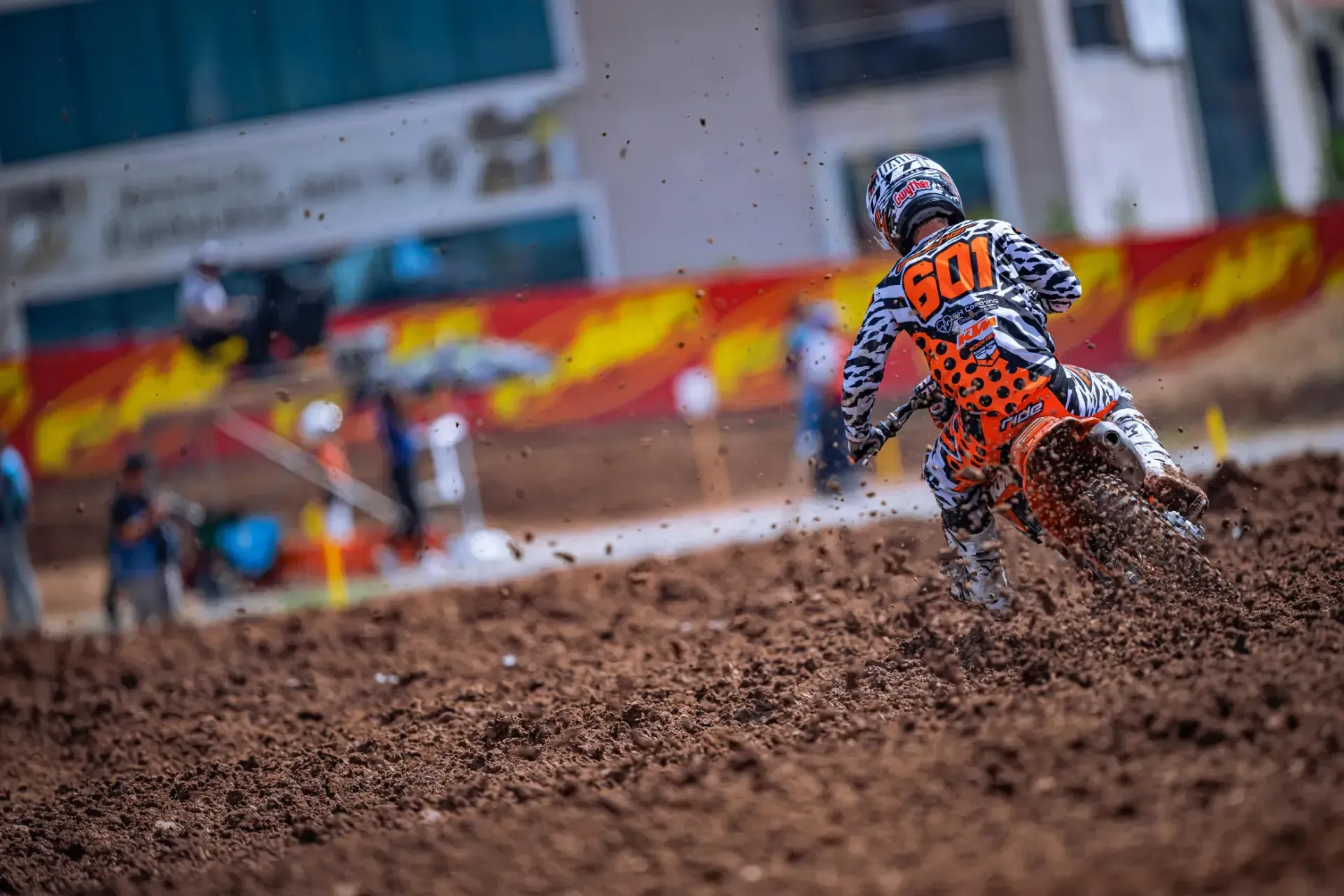 A person is riding a dirt bike on a dirt track.