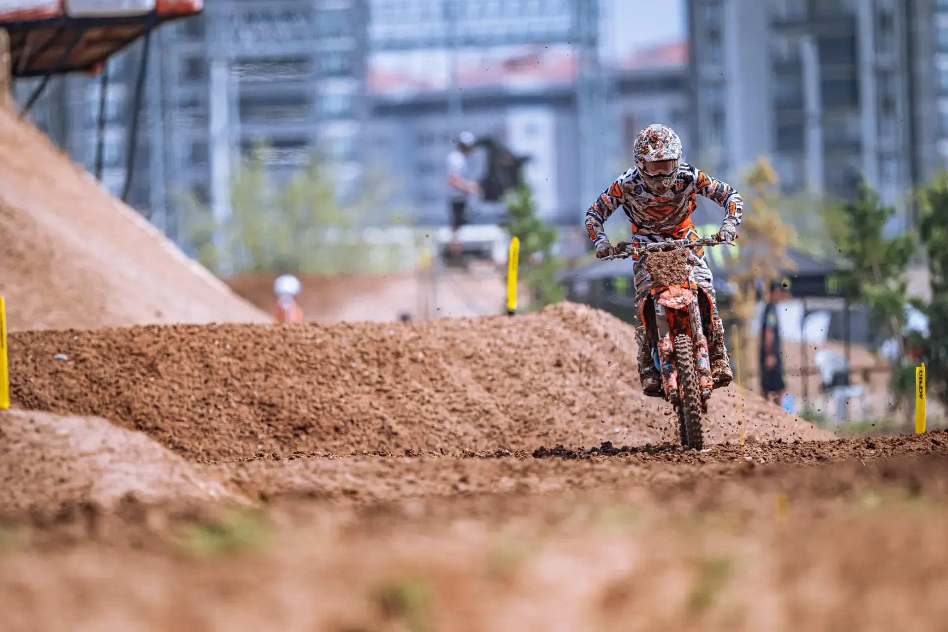 A person is riding a dirt bike on a dirt track.