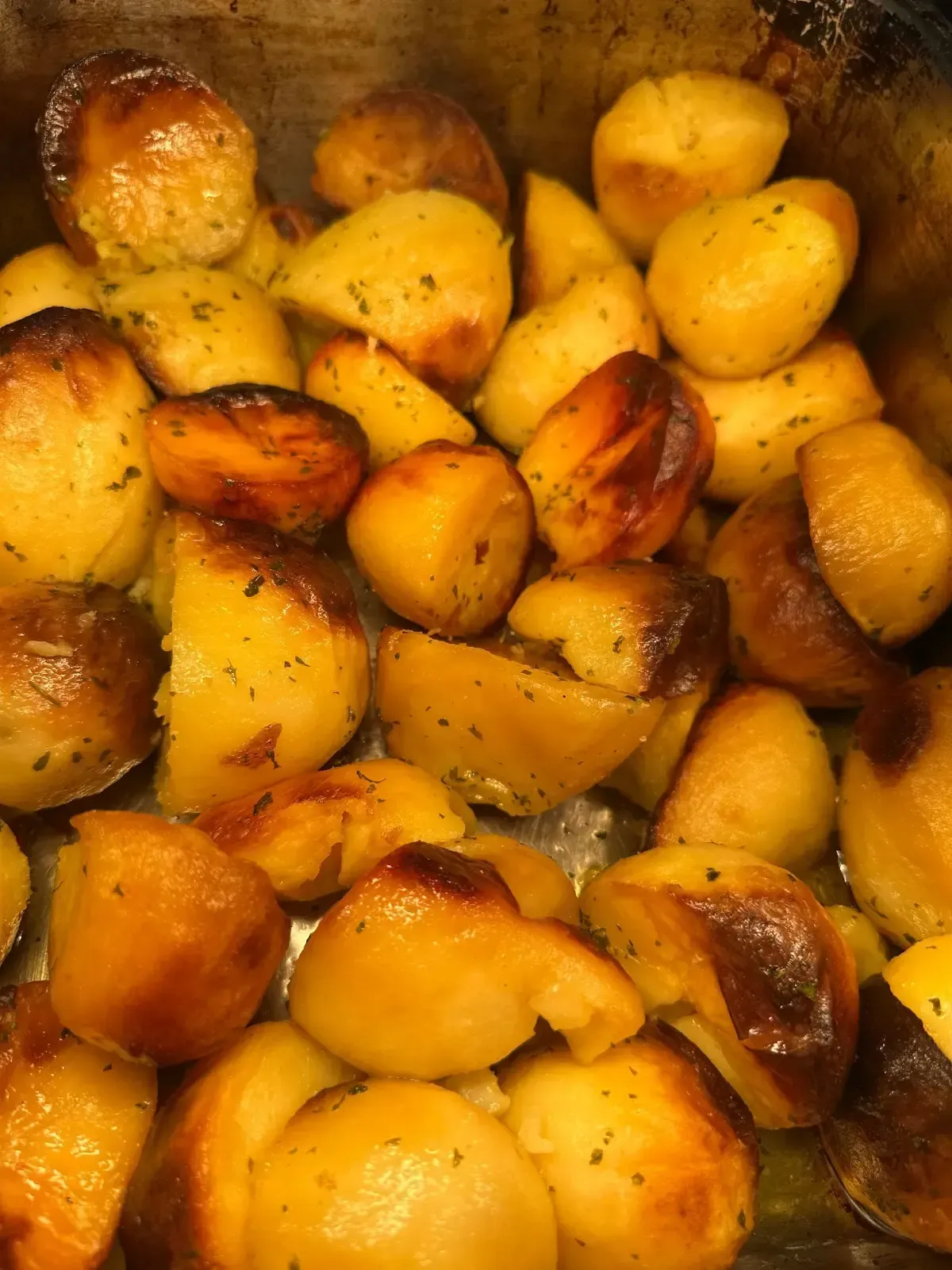 The Mackworth Arms, Laleston, Bridgend | Golden roasted potatoes in a metal pan, sprinkled with herbs.