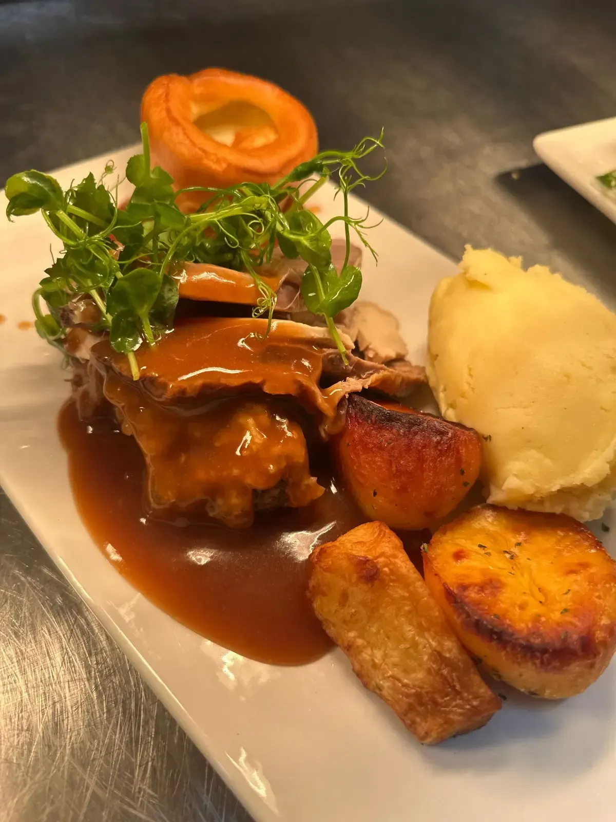 The Mackworth Arms, Laleston, Bridgend | Roast dinner on a white plate: meat with gravy, Yorkshire pudding & mash.