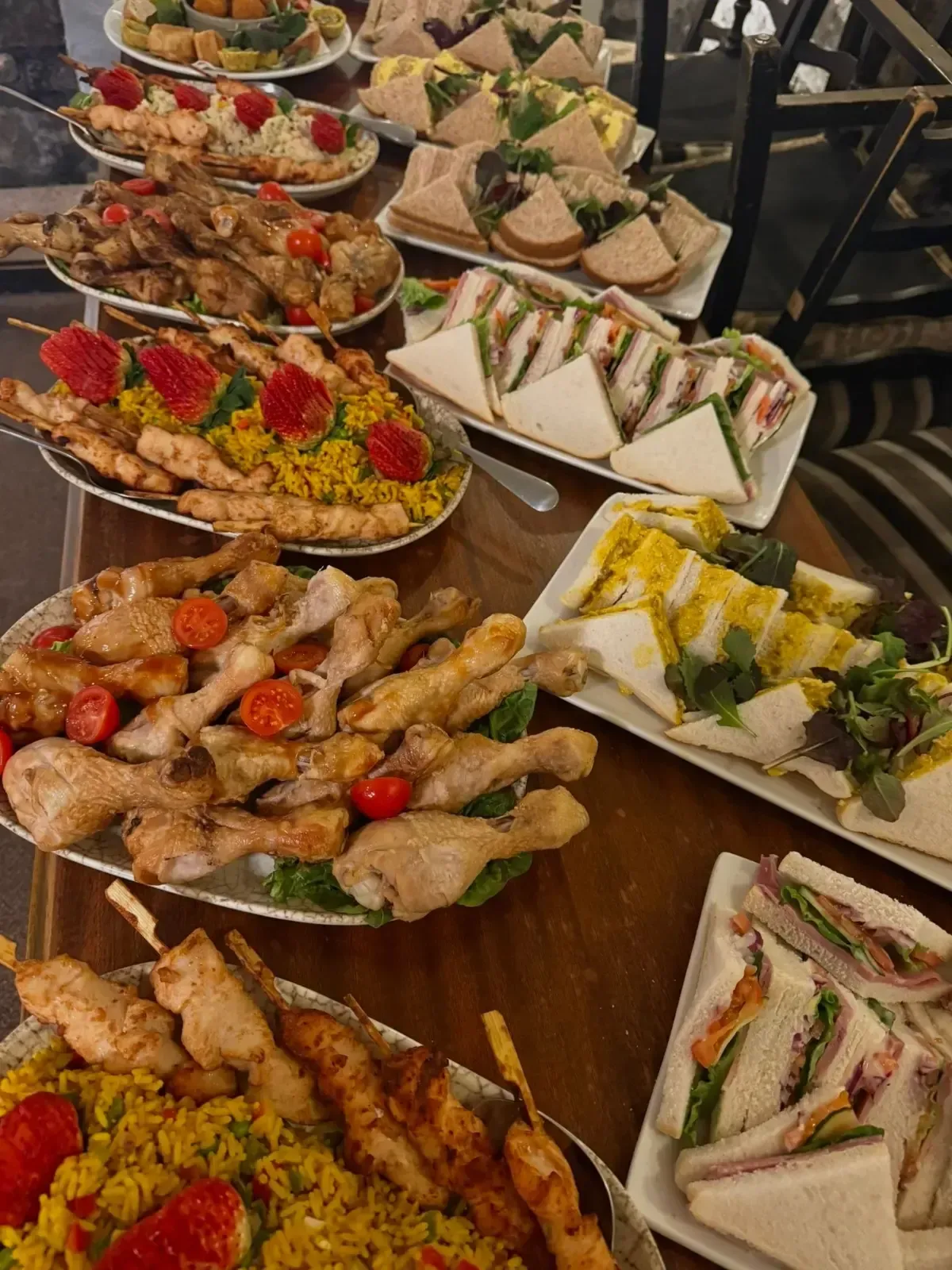 The Mackworth Arms, Laleston, Bridgend | Table of food, including sandwiches, skewers, and drumsticks; catering setup.