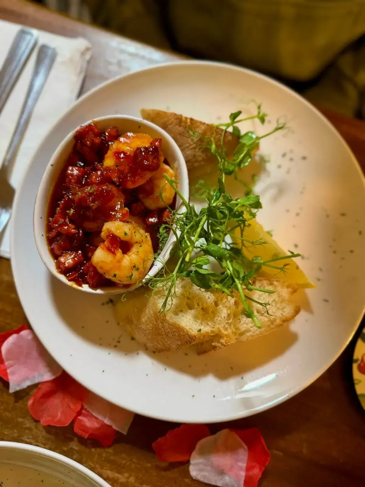 The Mackworth Arms, Laleston, Bridgend | Shrimp in tomato sauce, served with toasted bread and microgreens on a white plate.