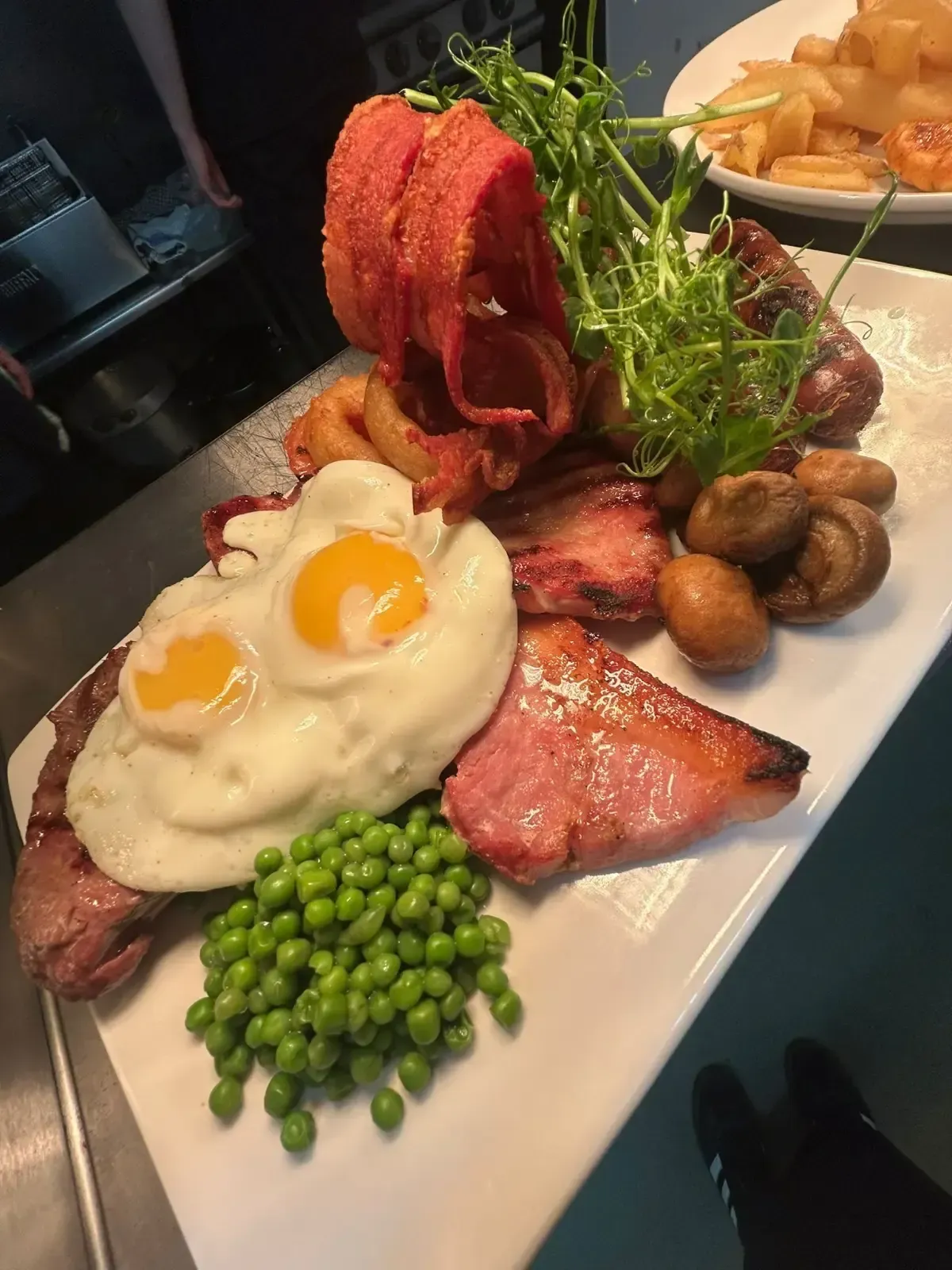 Mackworth Arms, Dinner Menu | Pasta with meatballs, red sauce, and herbs in a white bowl, with garlic bread.