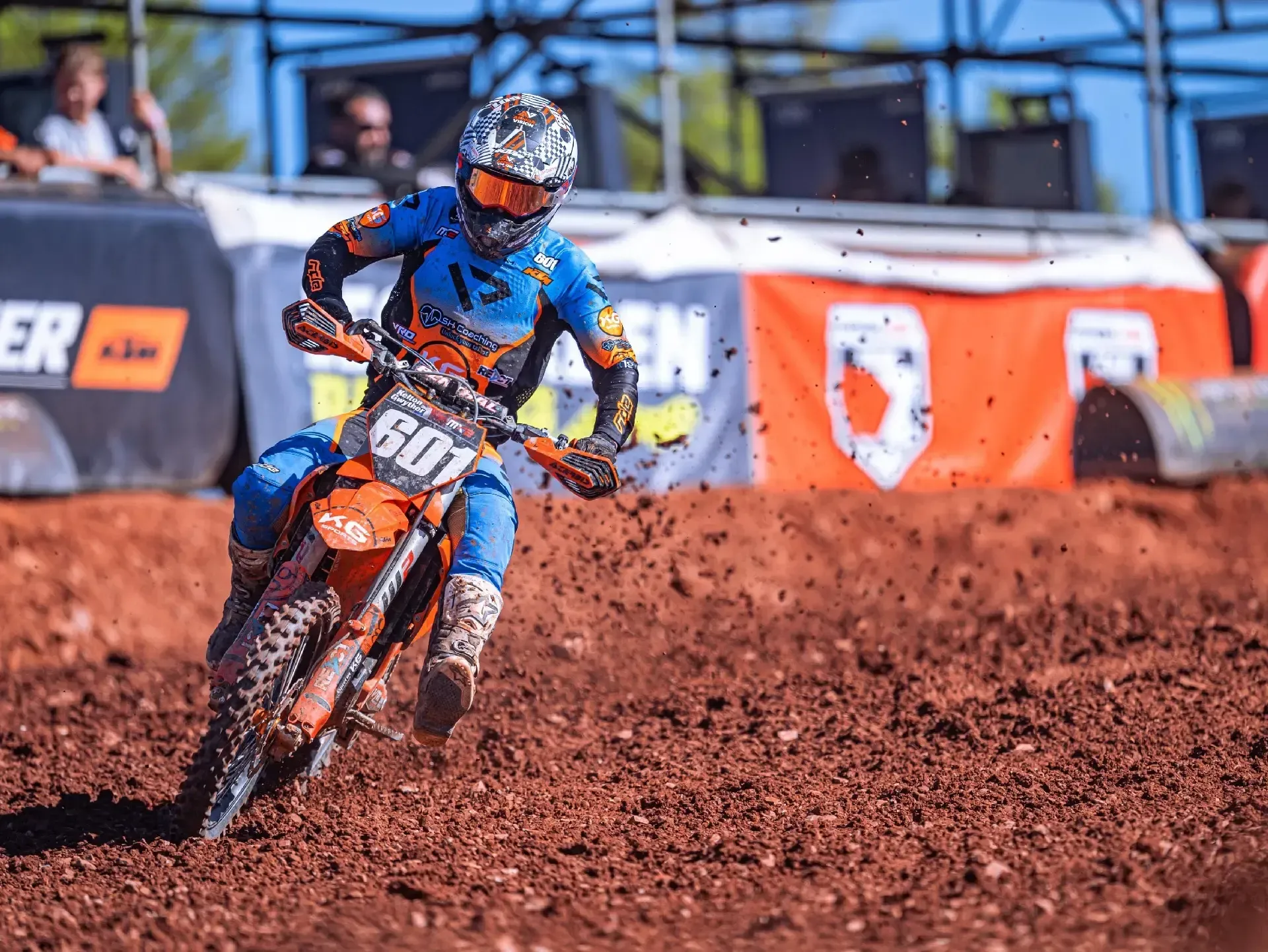A person is riding a dirt bike on a dirt track.