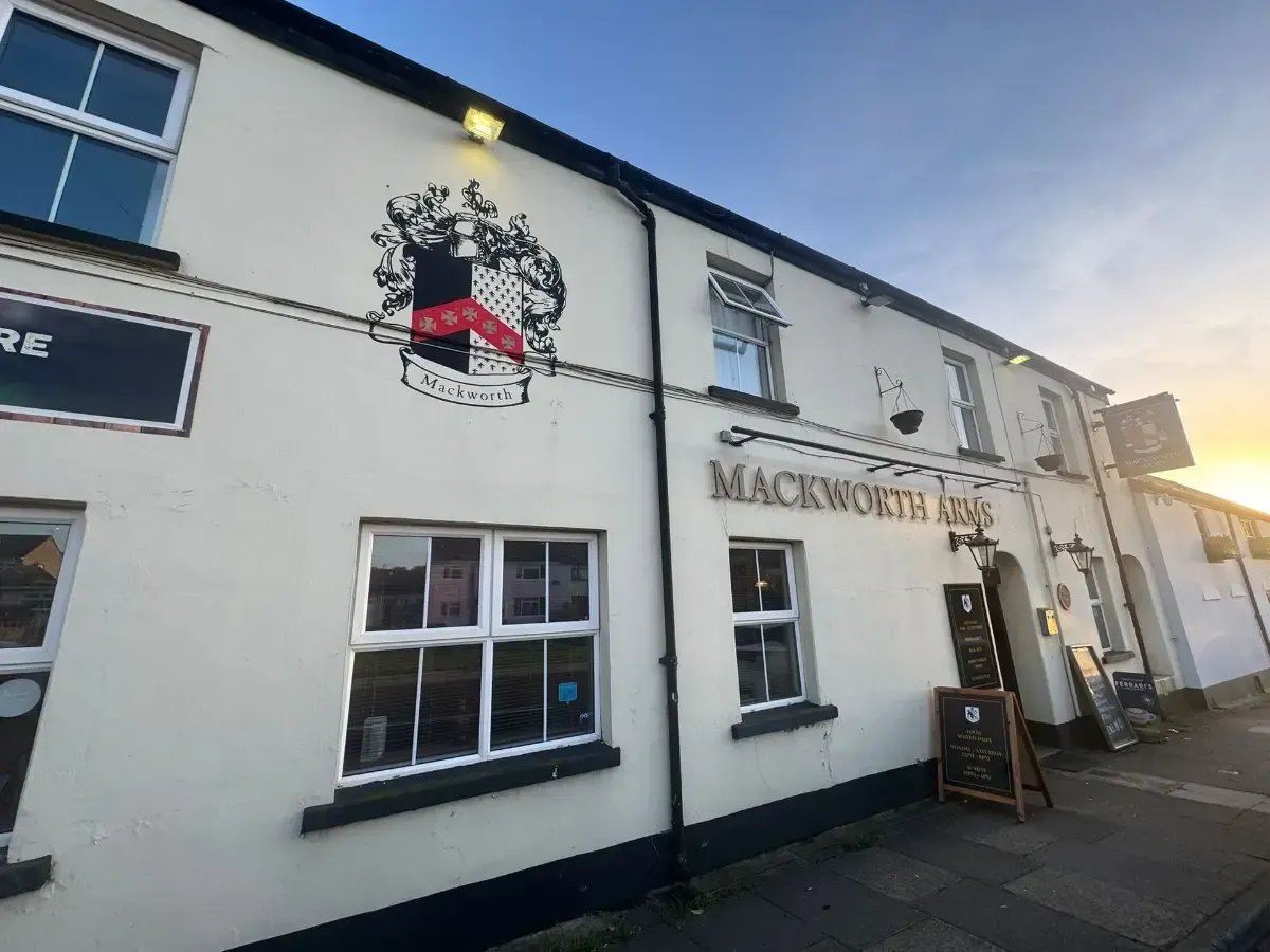 The Mackworth Arms, Laleston, Bridgend | Mackworth Inn pub exterior with a coat of arms above the entrance, white walls