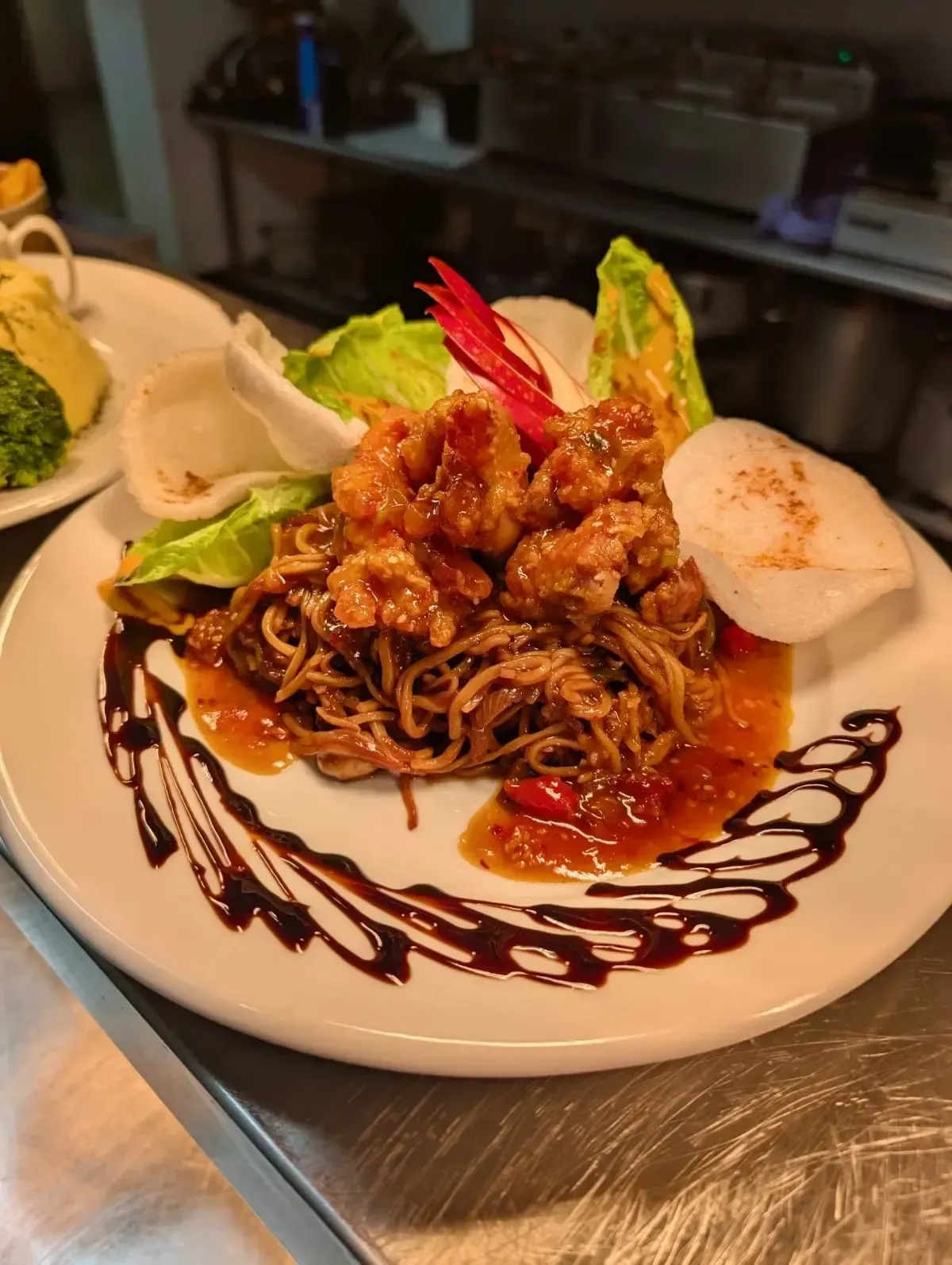 The Mackworth Arms, Laleston, Bridgend | Plate of Asian-inspired food: noodles, fried shrimp, sauce, lettuce, and crackers,