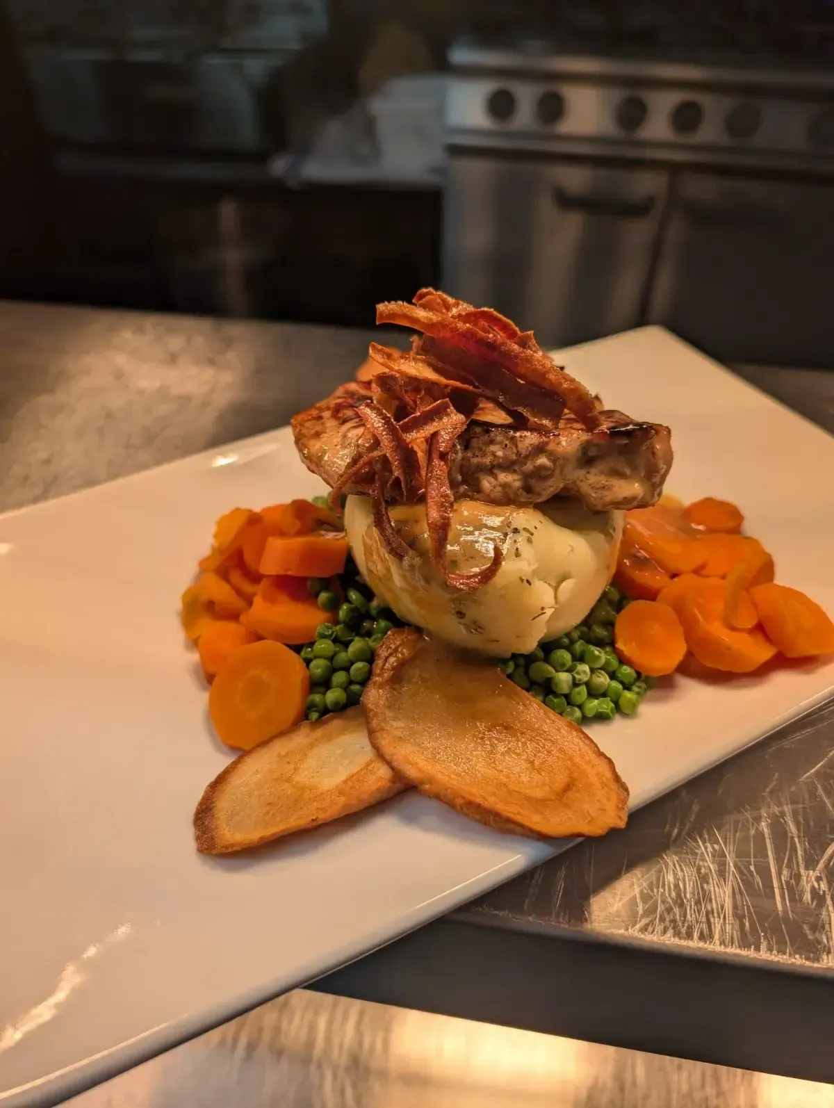 The Mackworth Arms, Laleston, Bridgend | Plate of food: roasted meat, mashed potato, peas, carrots, and fried onion garnish.