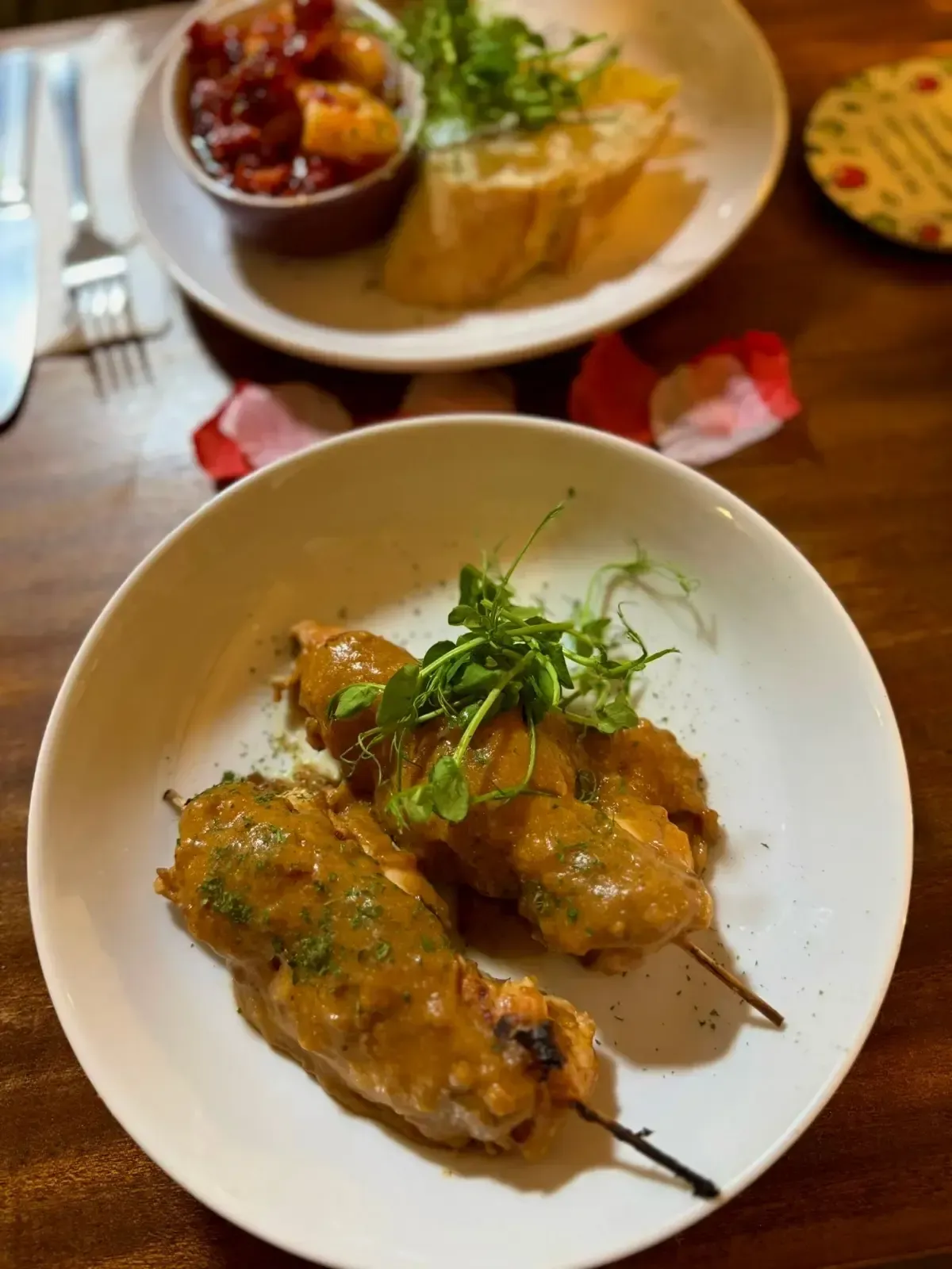 The Mackworth Arms, Laleston, Bridgend | Two kebabs in sauce on a white plate, small side dish with bread and chutney.