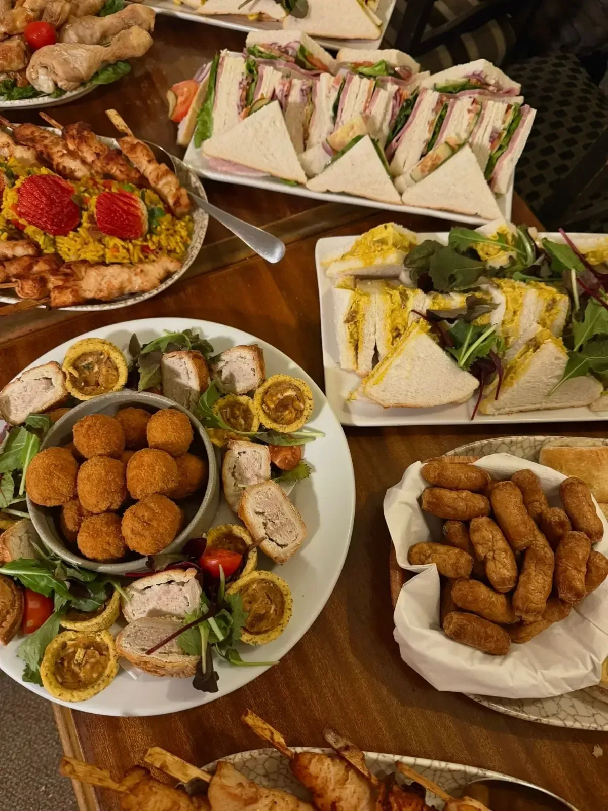 The Mackworth Arms, Laleston, Bridgend | Table set with various appetizers, including sandwiches, skewers, and fried snacks.