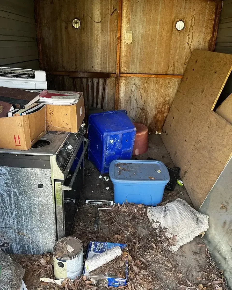 junk inside shed before cleanout and removal