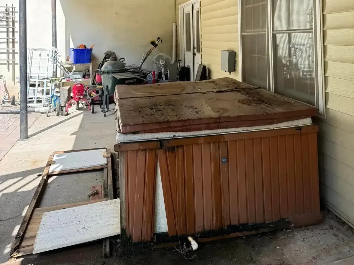 old wood-framed hot tub on covered patio
