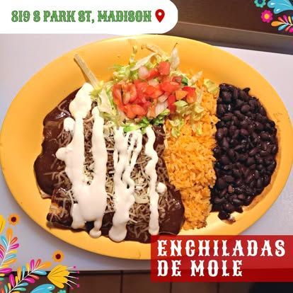 Enchiladas de mole on a yellow plate with rice, beans, and toppings. Located at 819 S Park St, Madison.