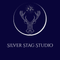 silver stage logo navy blue background silver writing with a stag symbol 

