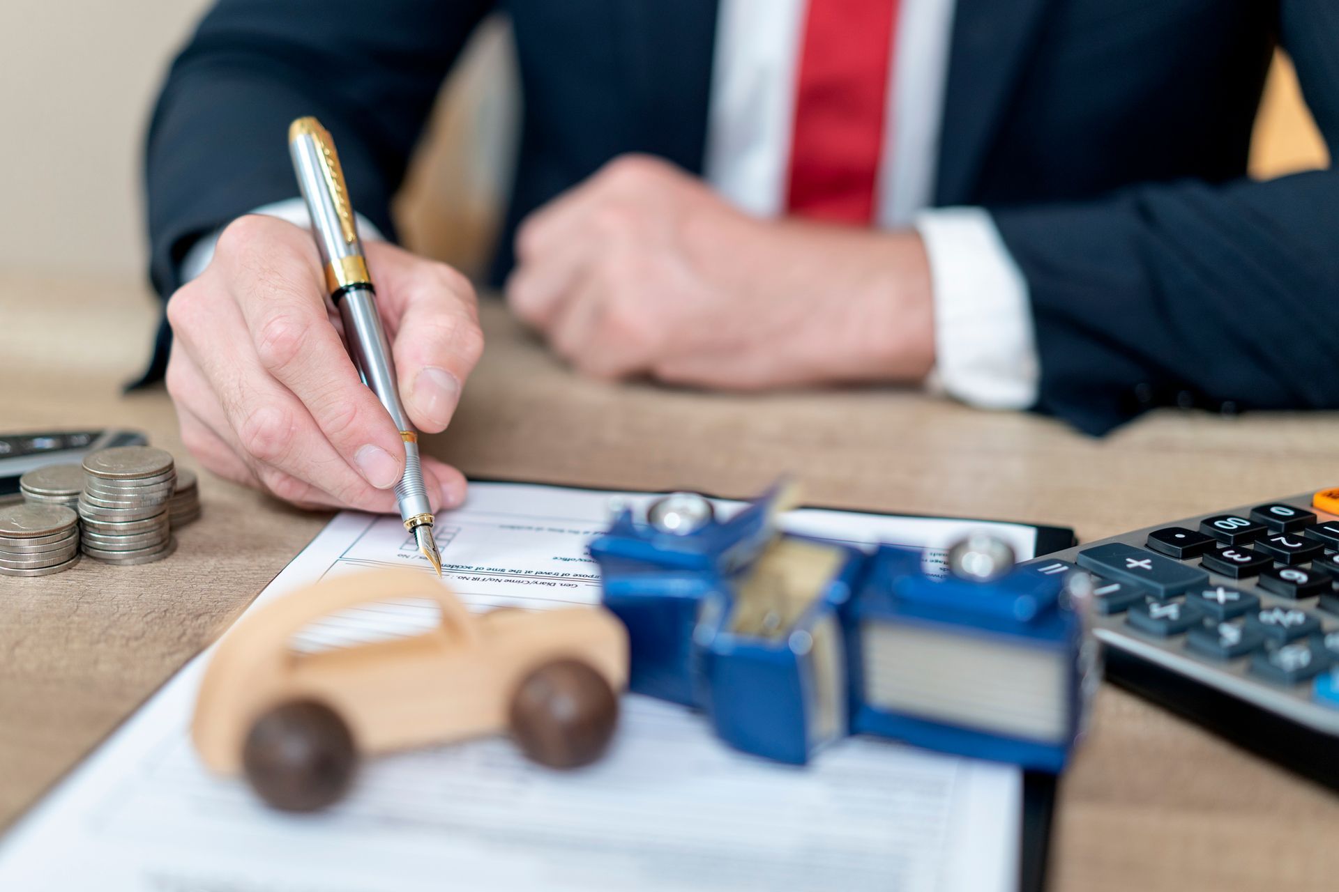 Attorney hand signing contract on document about auto accident. Attorney hand signing contract on document about auto accident.