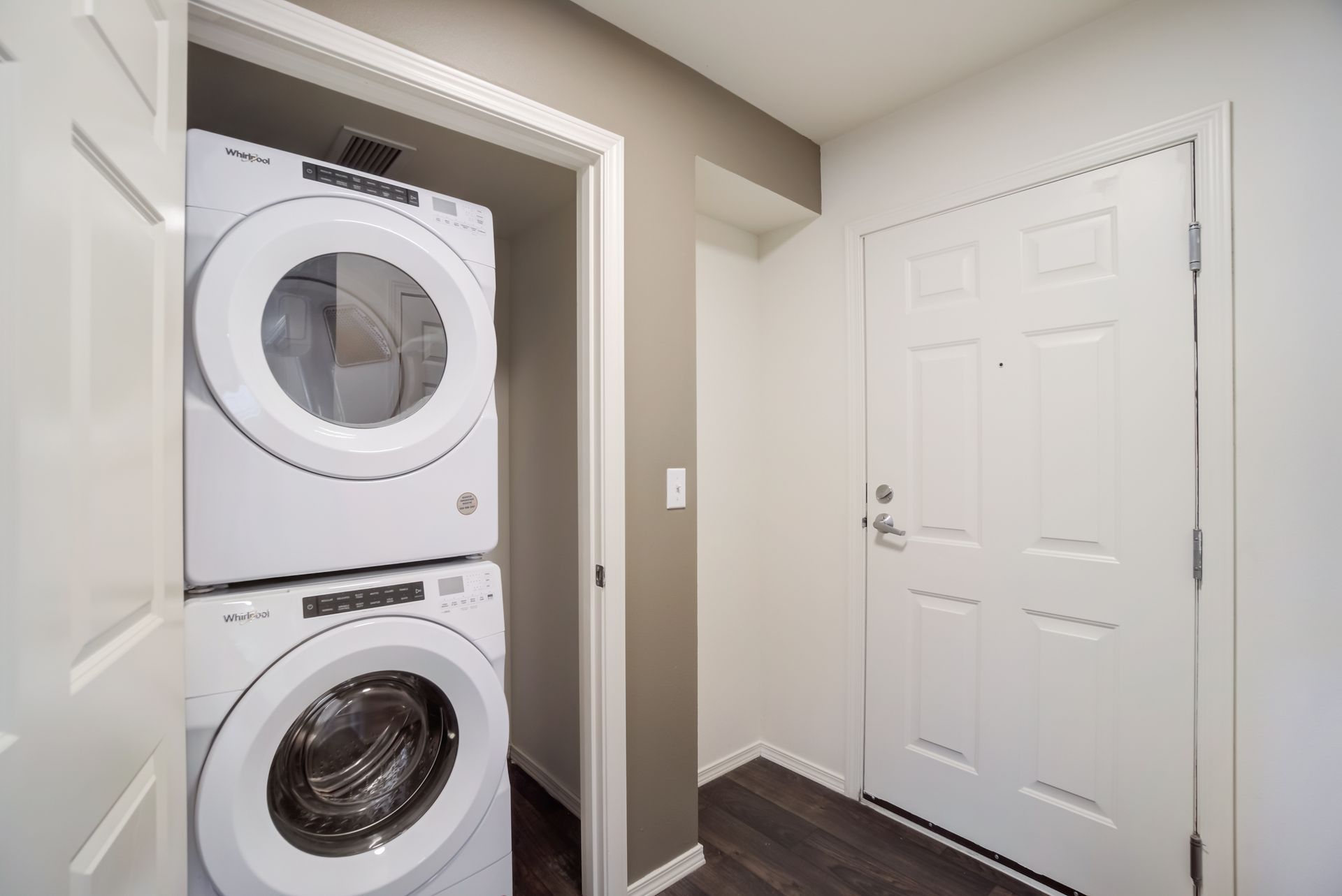 A washer and dryer are stacked on top of each other in a laundry room.