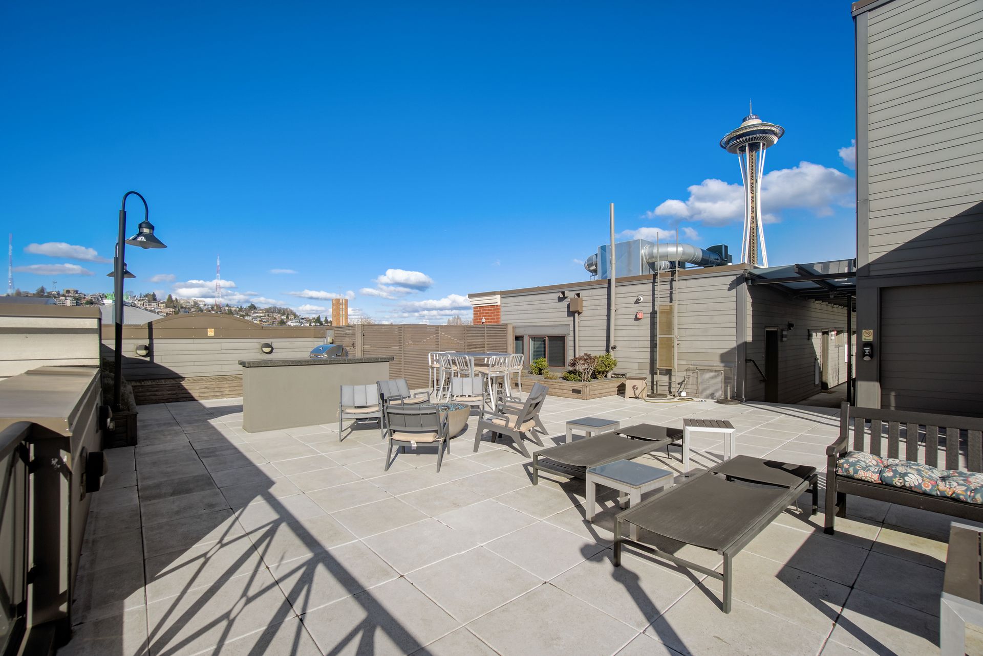 A rooftop deck with a view of the space needle.