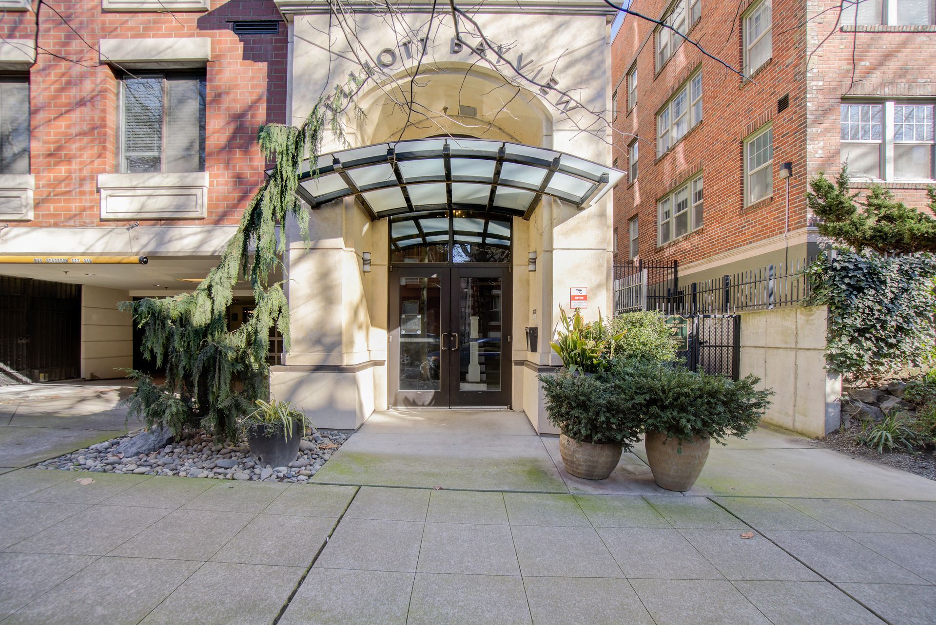 A brick building with a glass canopy over the entrance.