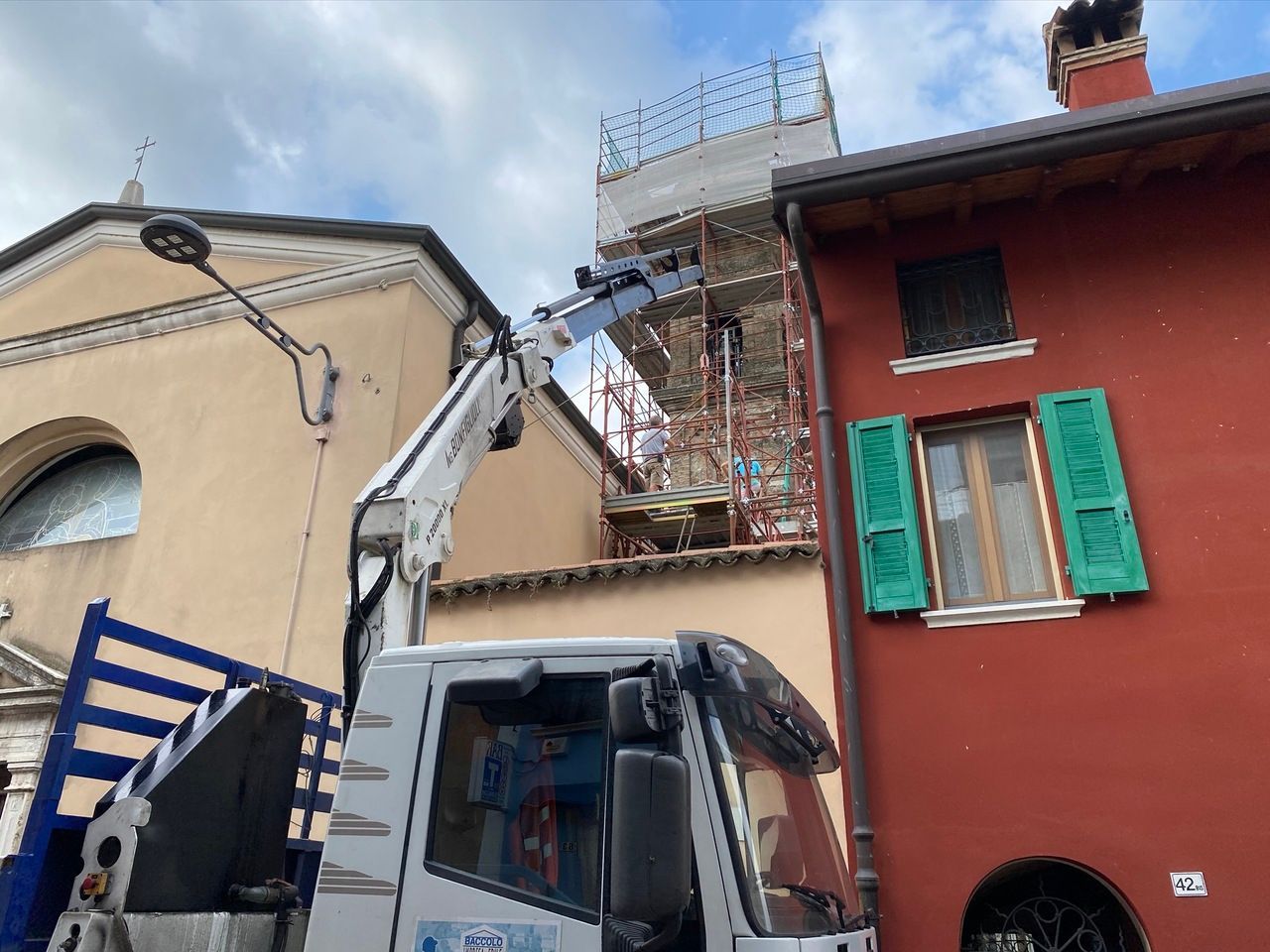 Un camion gru è sta portando materiale edile su impalcature