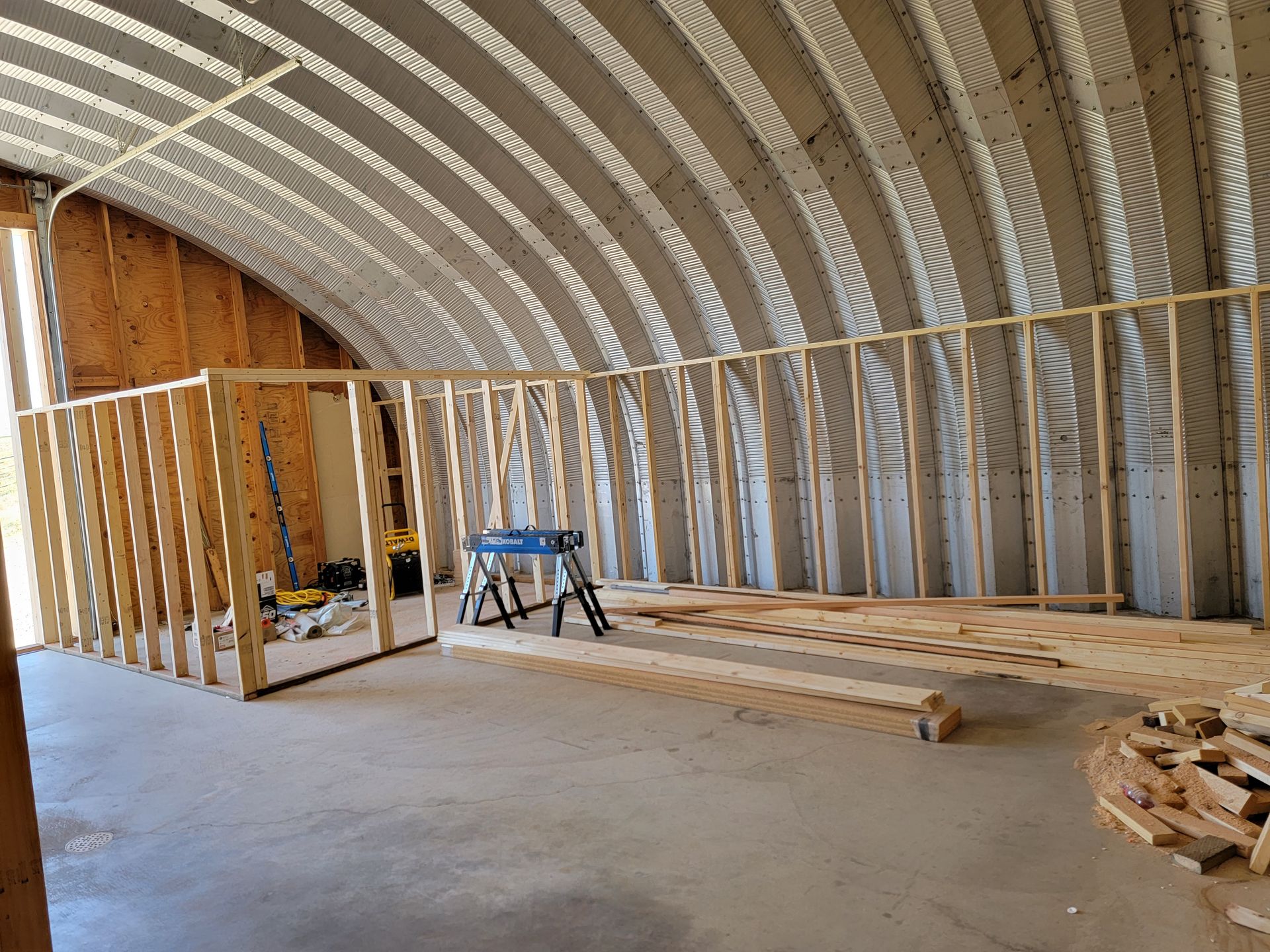 The inside of a building under construction with wooden beams.