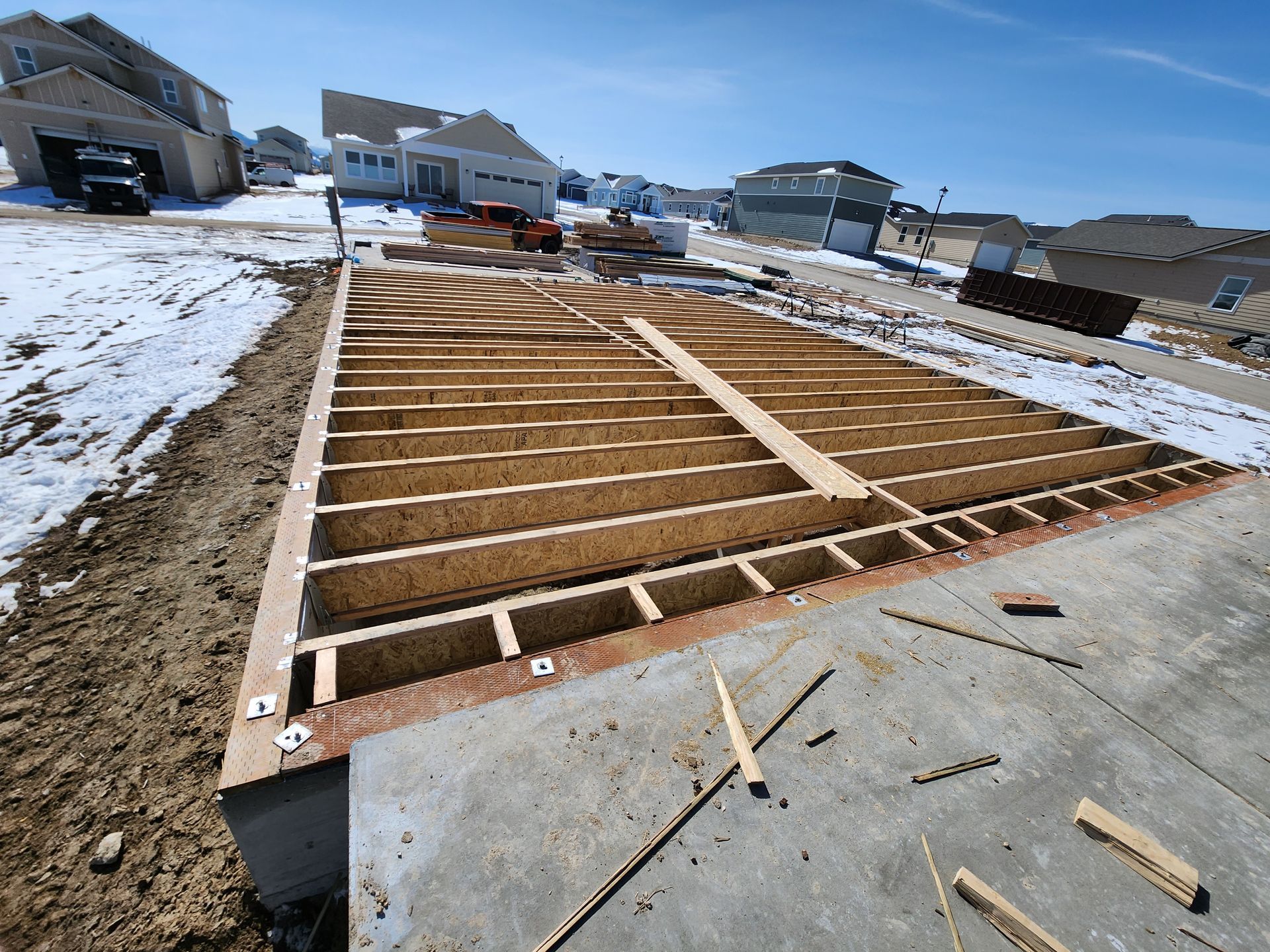 A wooden deck is being built in a residential area