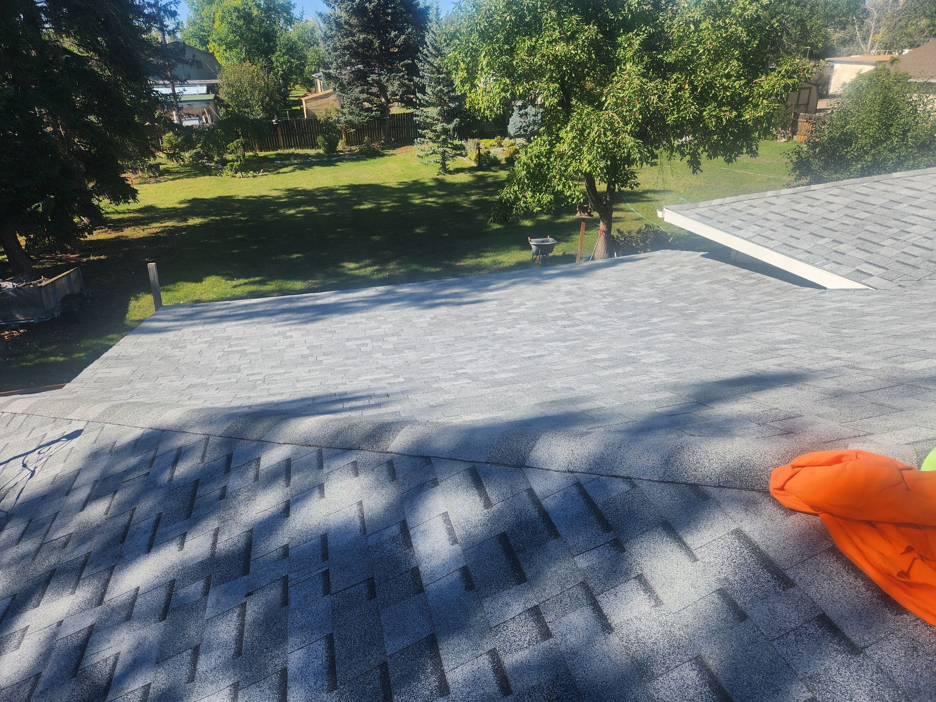 A person is sitting on the roof of a house.