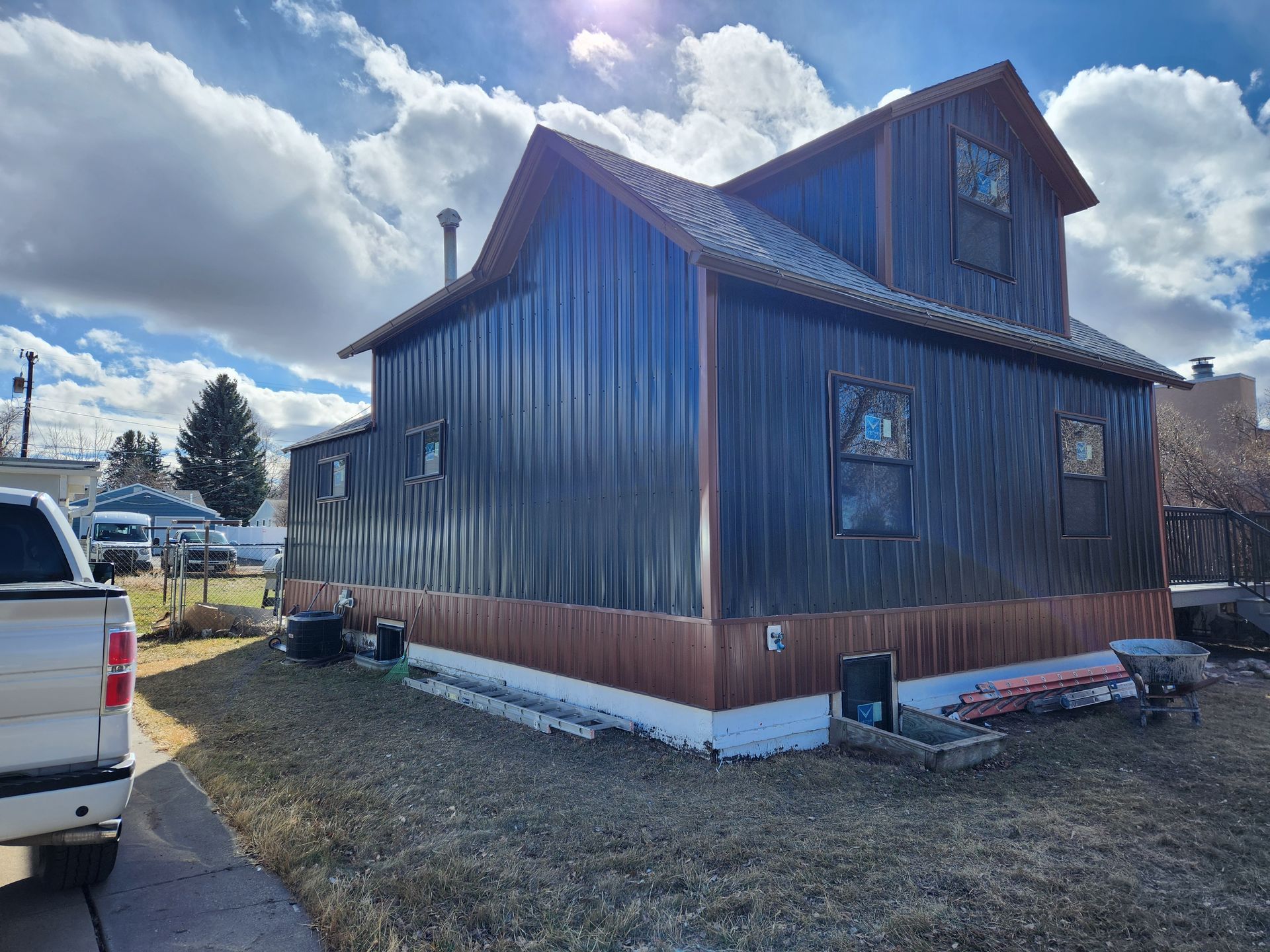 A house with a truck parked in front of it.