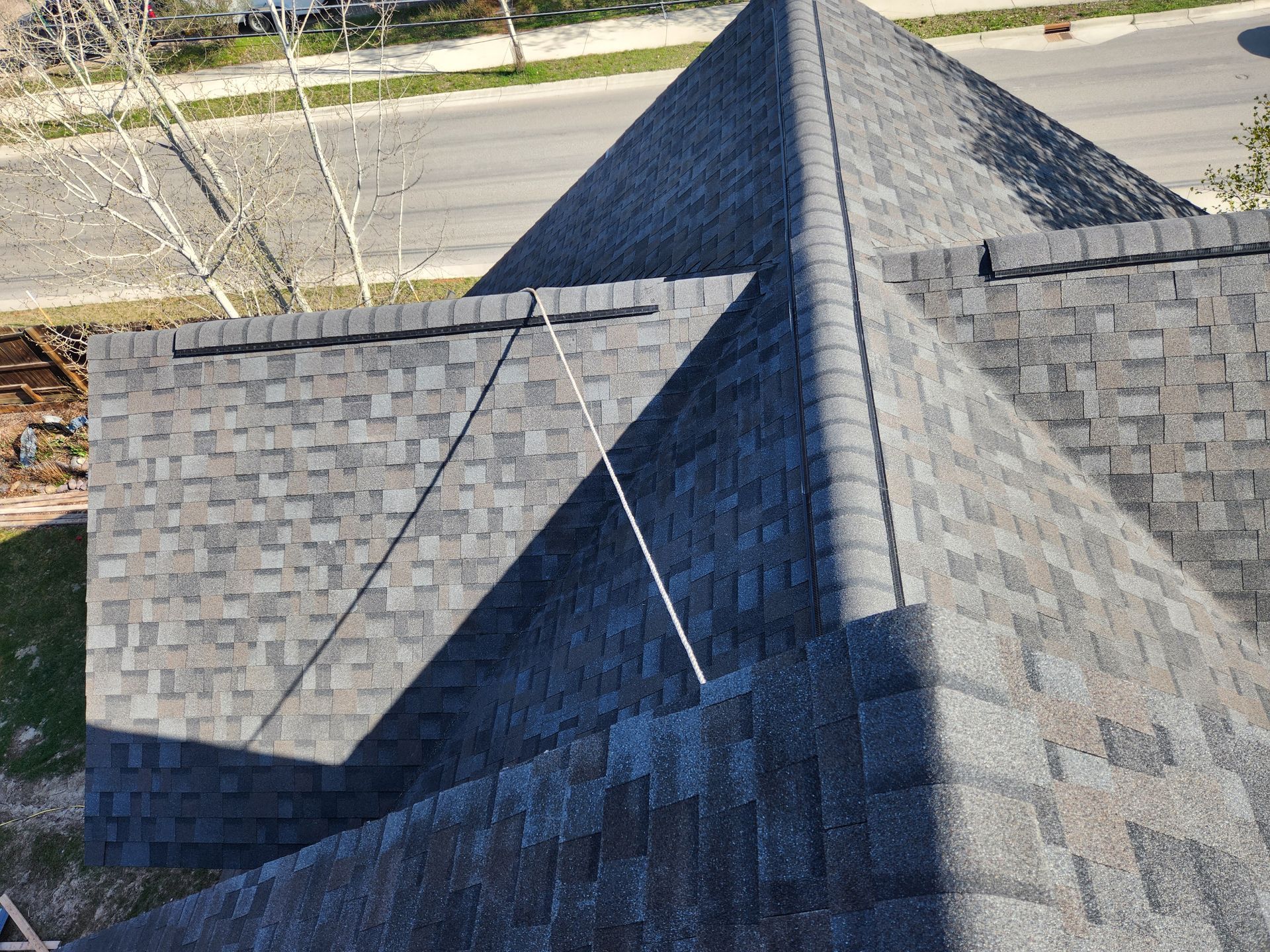 A roof with a lot of shingles and a triangle shaped roof.