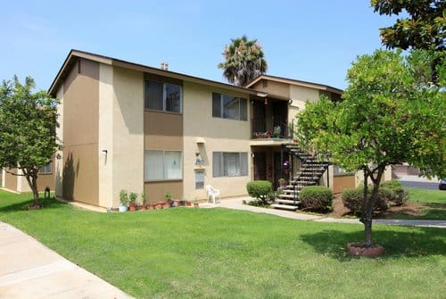 Exterior of a two story apartment building on a sunny day