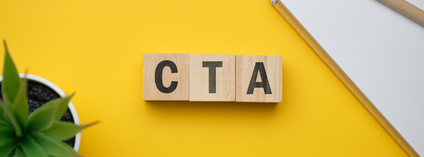 Three wooden blocks on a yellow background that spell out CTA