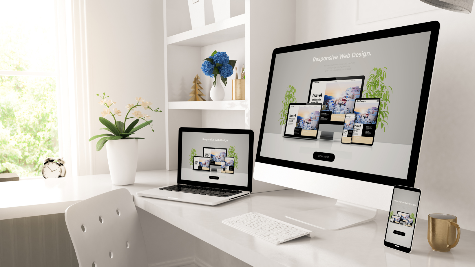 A desktop, laptop, smartphone, and a keyboard displaying responsive website design.