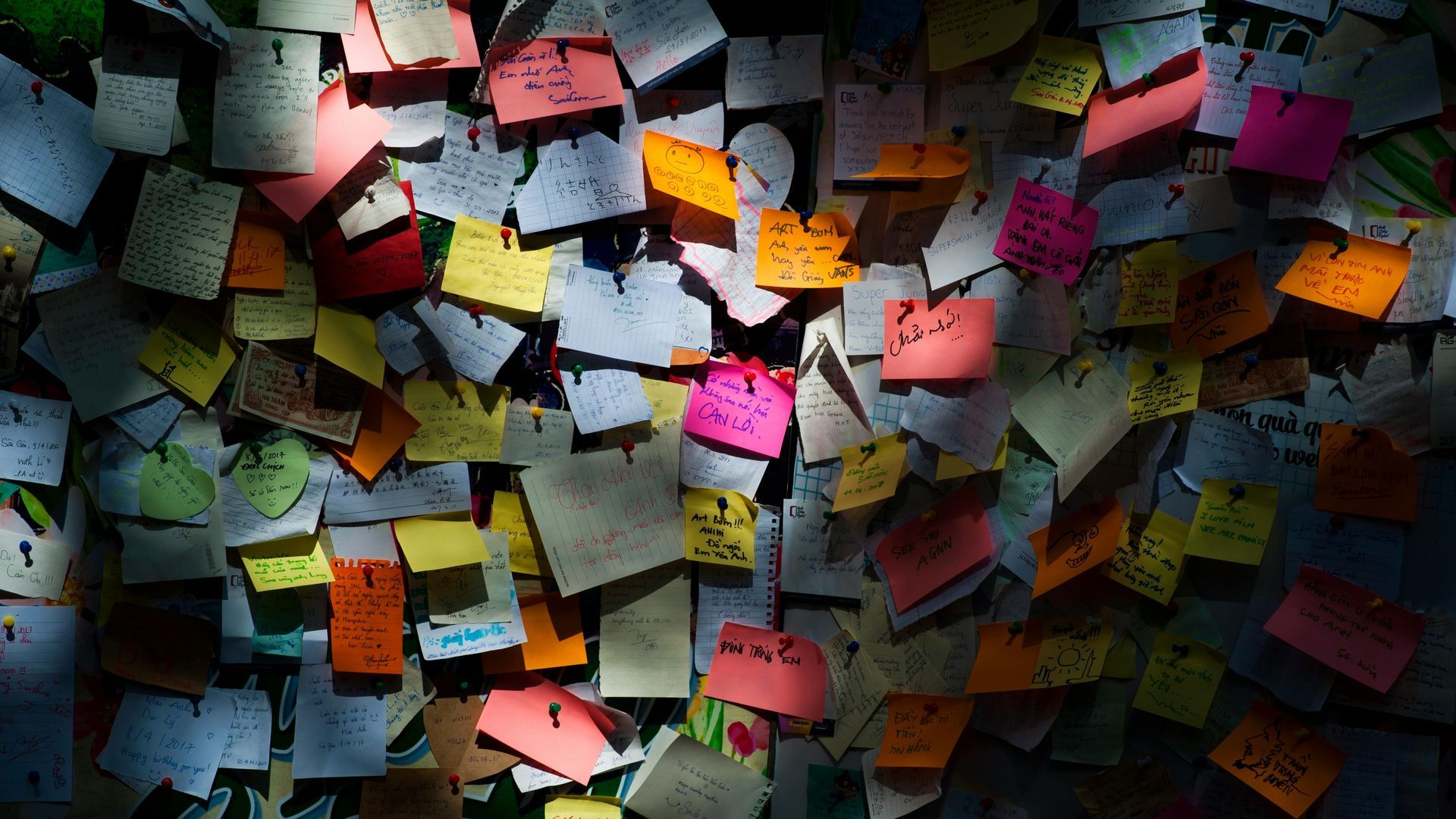 A wall that is covered with sticky notes is a disorganized mess.