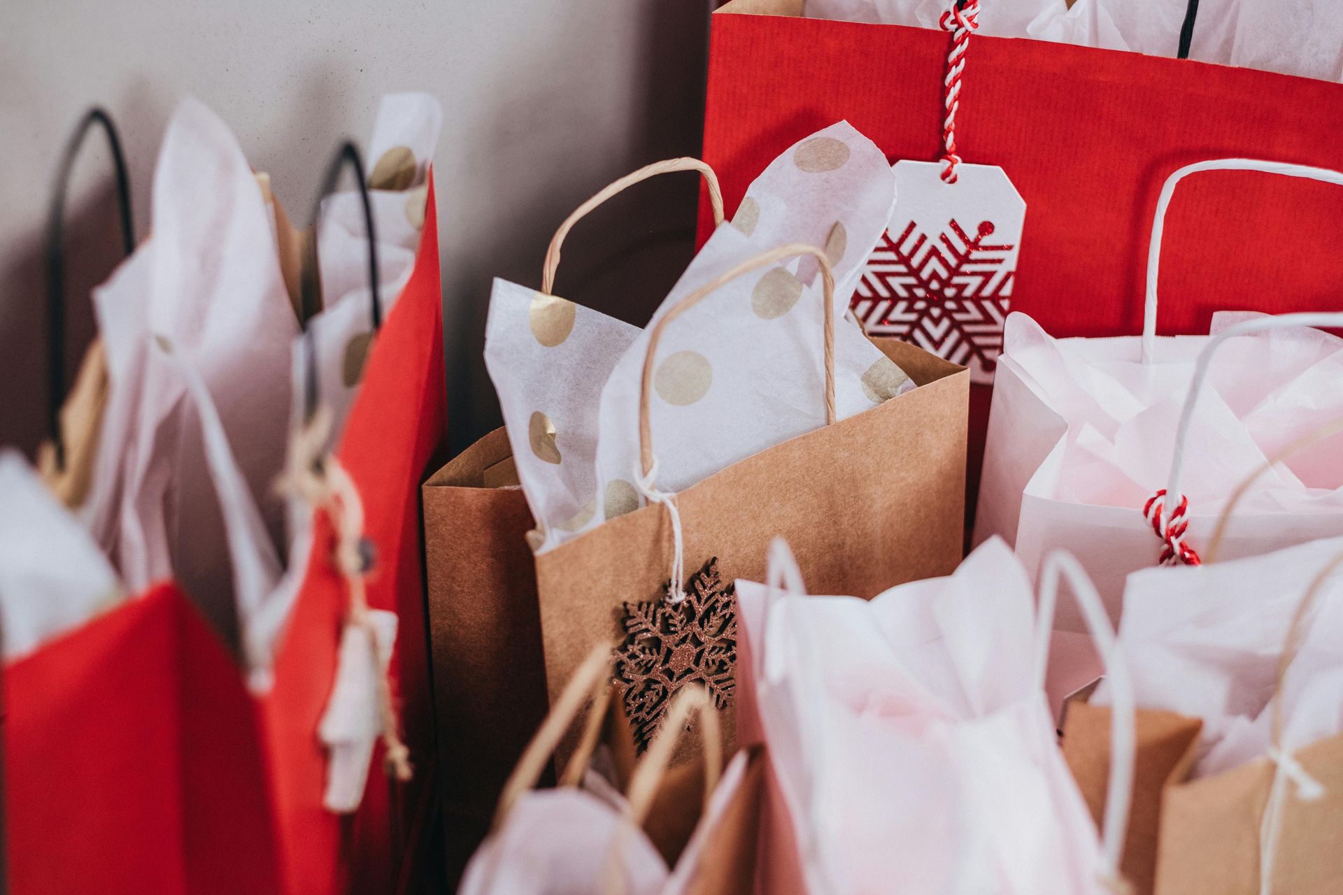 A bunch of shopping bags with snowflakes on them