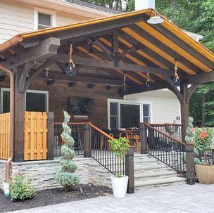 A house with a covered porch and stairs leading to it.