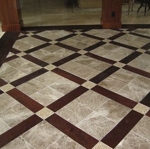 A marble floor with a wooden border and a checkered pattern.