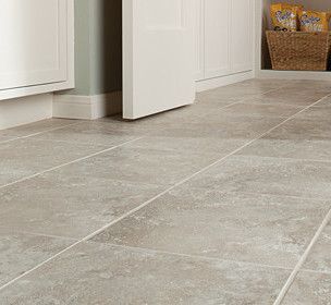 A close up of a tiled floor in a kitchen.