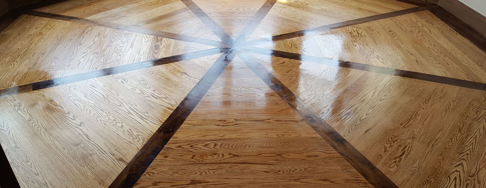 A close up of a wooden floor with a pattern on it.