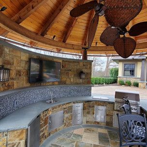 There is a ceiling fan hanging from the ceiling in the gazebo.