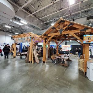 A group of people are standing around a wooden structure in a building.