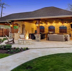 There is a fire pit in the backyard of a house.